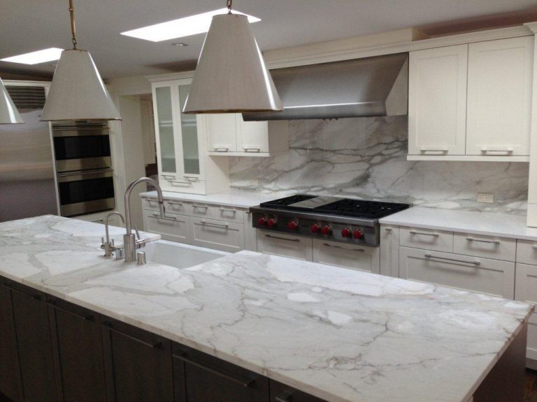 White marble countertop island in a bright kitchen