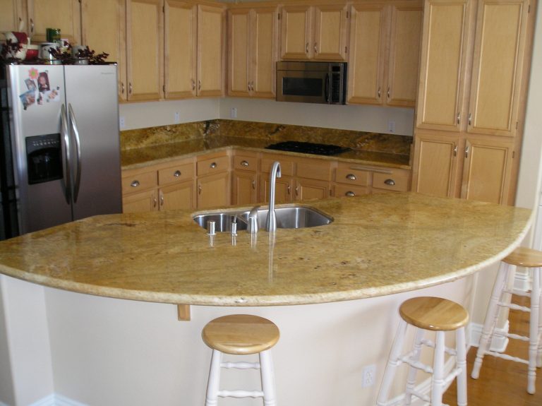 Curved granite breakfast bar in a remodeled home